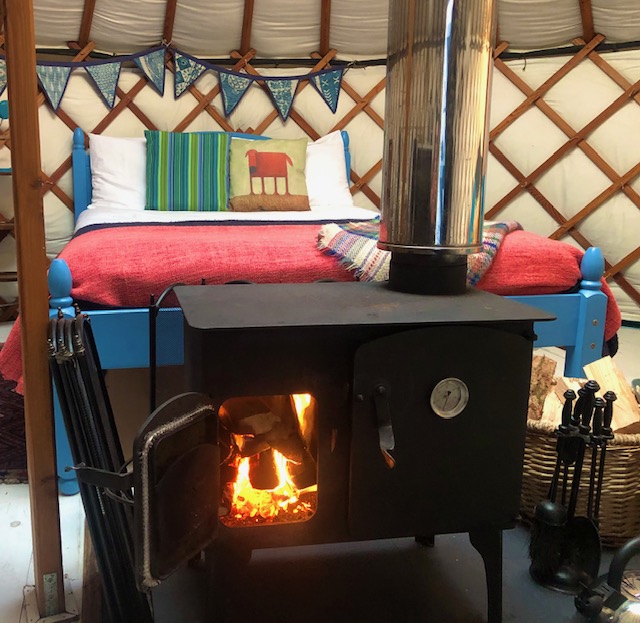 the yurt contains a log burning stove which incorporates a hotplate and oven